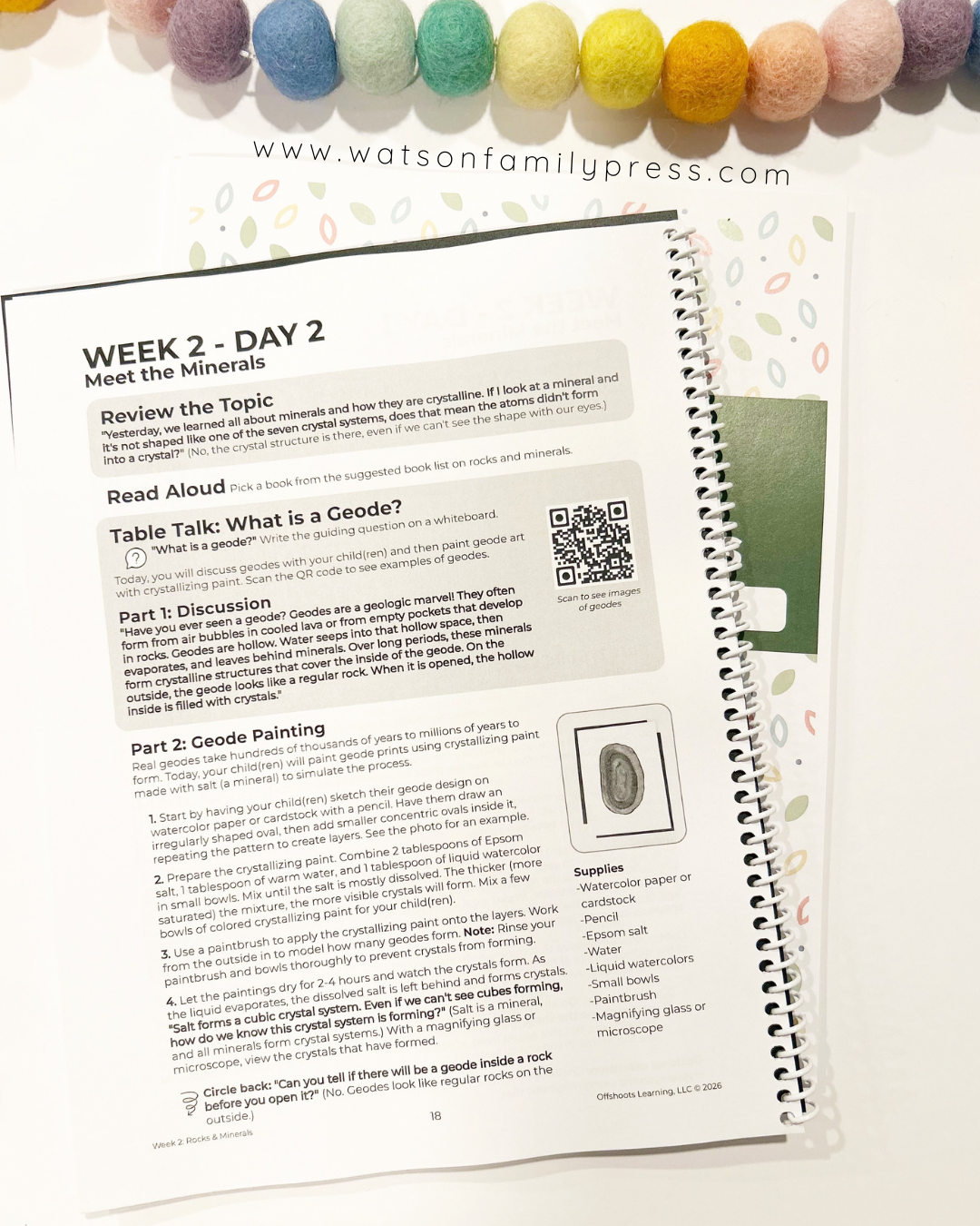 Educational book or planner with text and a QR code on a white background