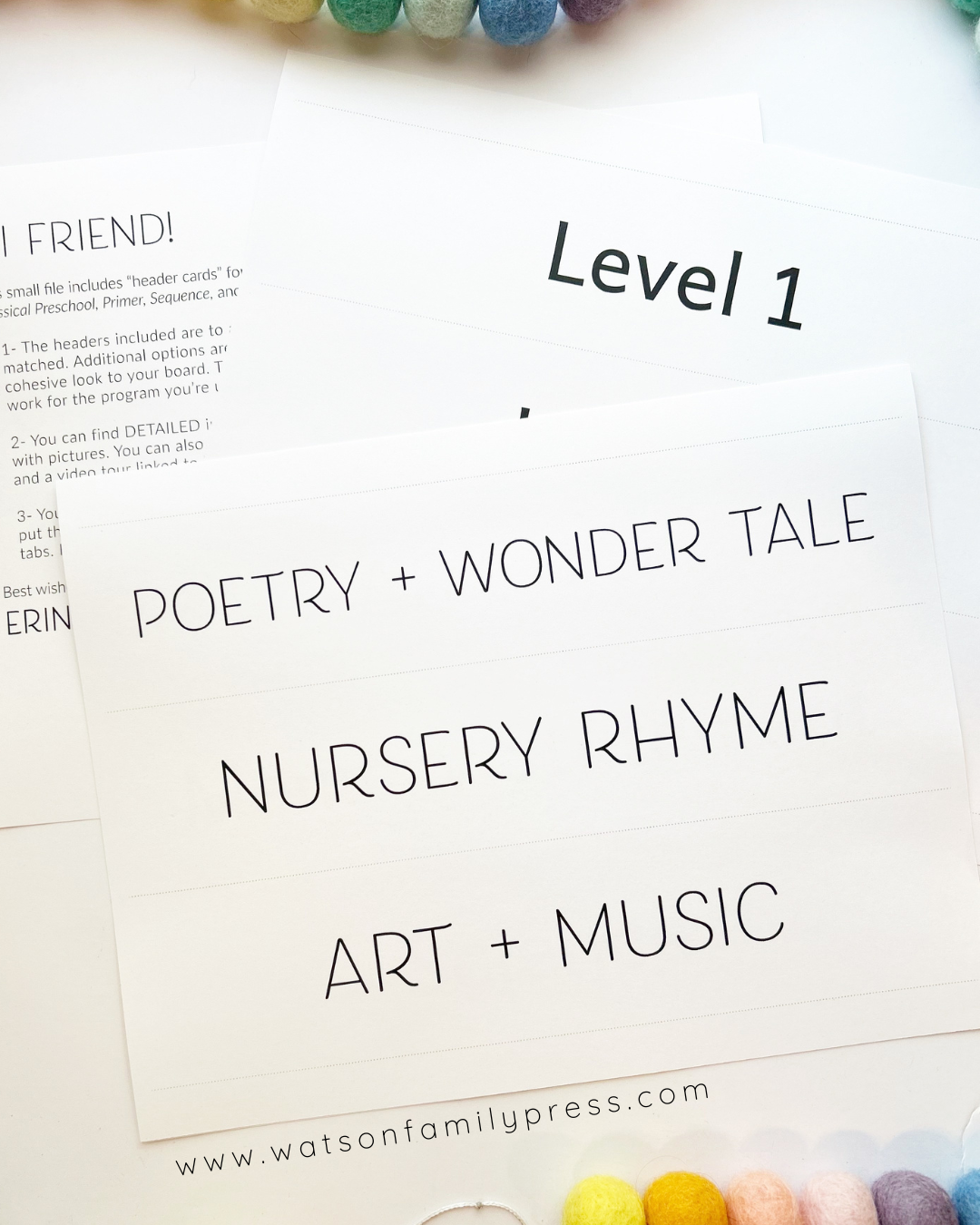 A close-up of a printed children's activity sheet titled 'Level 1 Poetry + Wonder Tale Nursery Rhyme Art + Music' with pastel craft supplies partially visible around the edges on a white background.