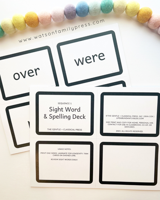 A printed card deck titled 'Sequence 1 Sight Word & Spelling Deck'  photographed on a light surface with colorful pom-poms around the edges.