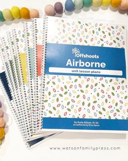 A collection of spiral bound unit lessons books of Offshoots Learning with colorful covers laid out on a white background.