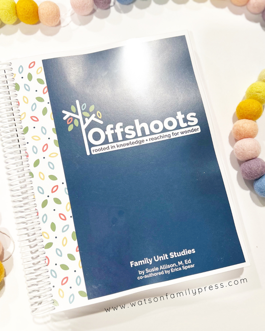 A spiral bound book with a colorful cover featuring the title 'Offshoots", which is a home learning curriculum by Susie Allison and Erica Spear. The cover has a pattern of colorful dots and the book is presented on a surface with various colorful items around it.