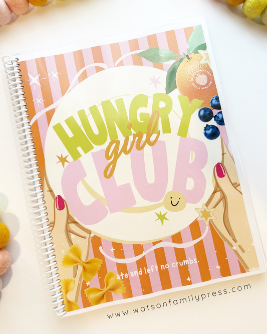 Notebook titled Hungry Girl Club by Makayla Thomas with a cover featuring a plate with 'Hungry Girl Club' text, bowtie pasta, blueberries and peach. Printed by Watson Family Press.