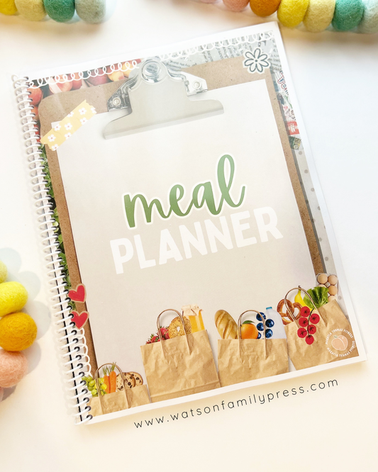 Notebook titled Meal Planner by Makayla Thomas with a cover featuring a clipboard with 'Meal Planner' text, brown bags of groceries. Printed by Watson Family Press.