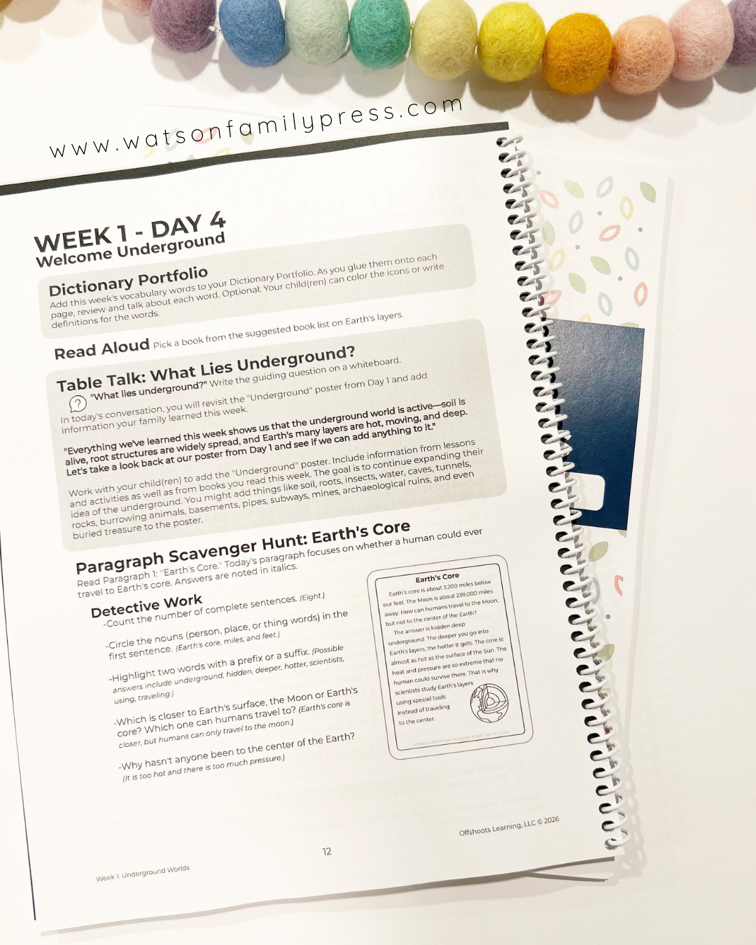 Open educational workbook with text and a colorful bead necklace on a white background