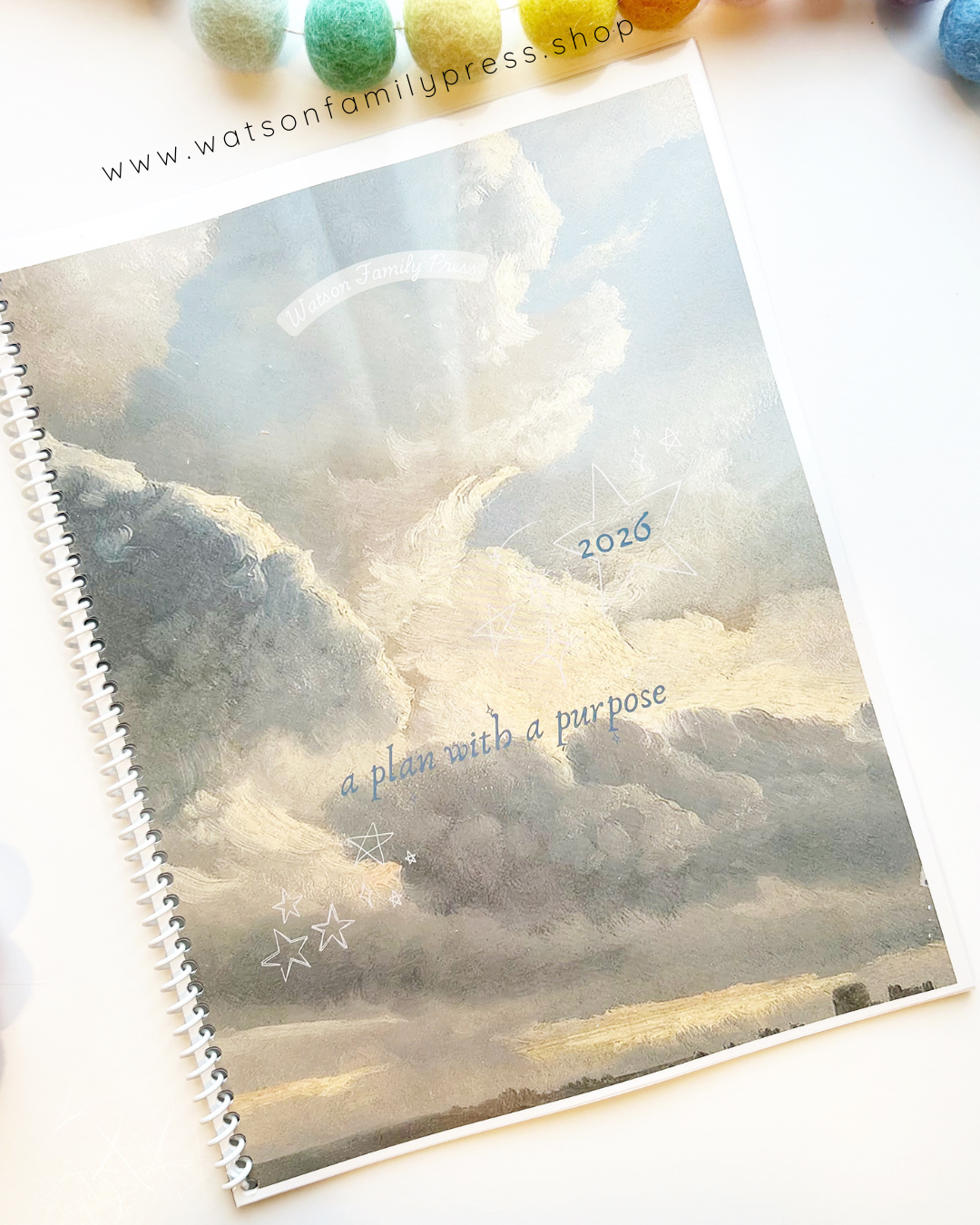 2026 planner with cloud painted design on a white surface