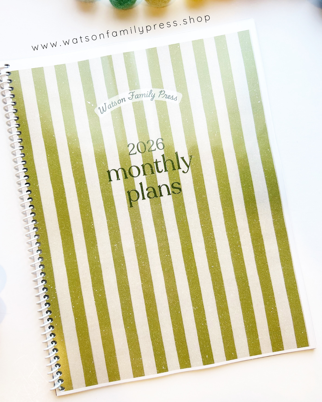 2026 monthly planner with vintage green and white striped cover on a white background